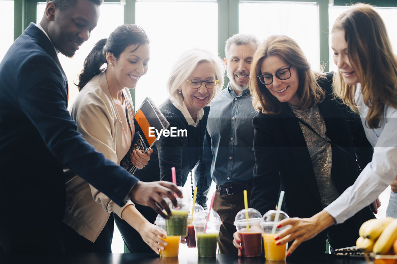 Business colleagues enjoying drinks during coffee break in conference