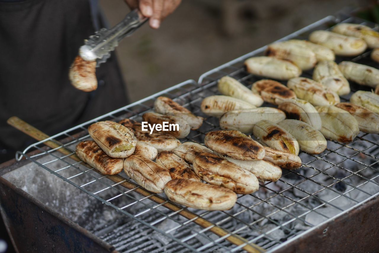 cropped hand of man preparing food