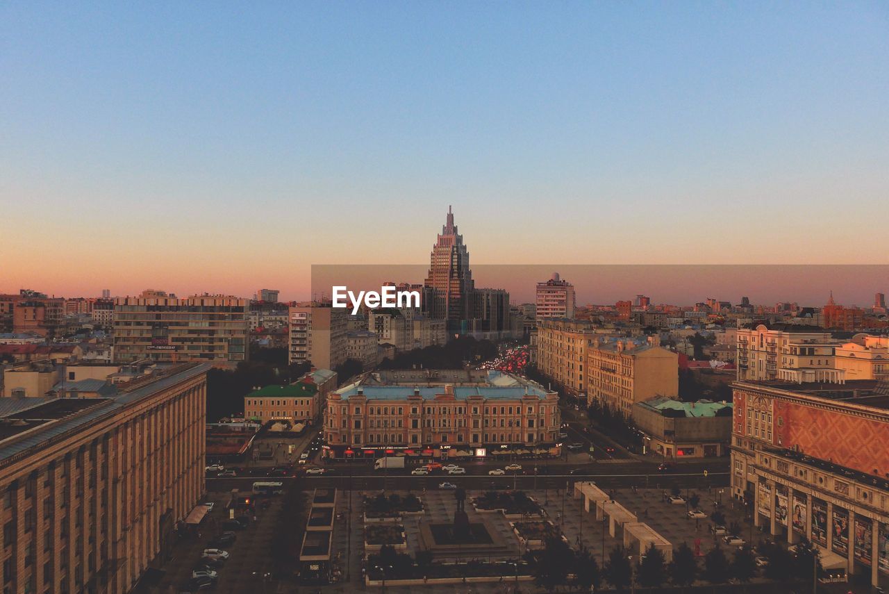 High angle view of buildings in city during sunset