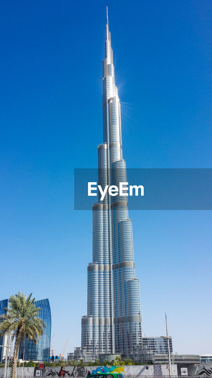 LOW ANGLE VIEW OF BUILDING AGAINST BLUE SKY