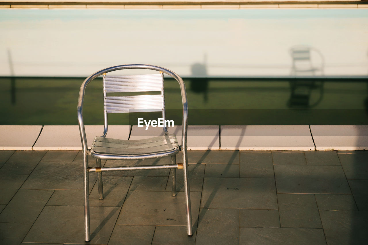 The Creative - 2019 EyeEm Awards Chair Stairs Absence Architecture Built Structure Chair Day Empty Flooring Italy Light And Shadow Metal Nature No People Outdoors Pool Poolside Reflection Seat Shadow Tiled Floor Water Visual Creativity