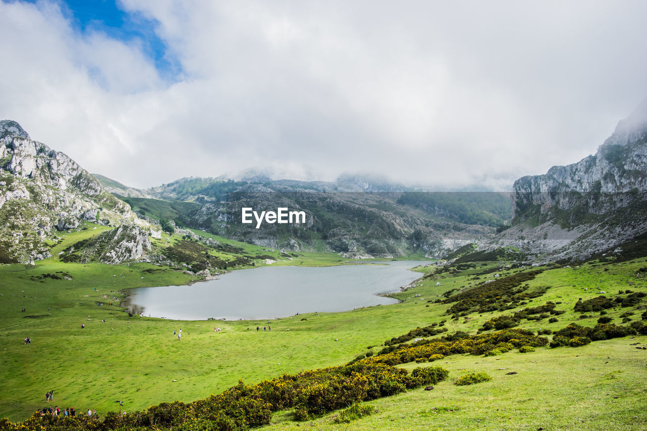 Scenic view of lake and mountains against sky