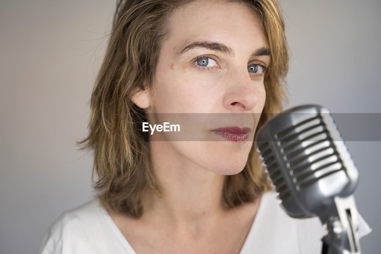 Portrait of beautiful woman with microphone