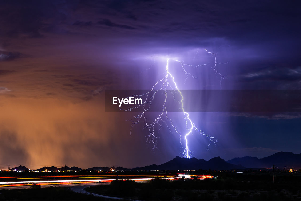 Lightning over illuminated city at night