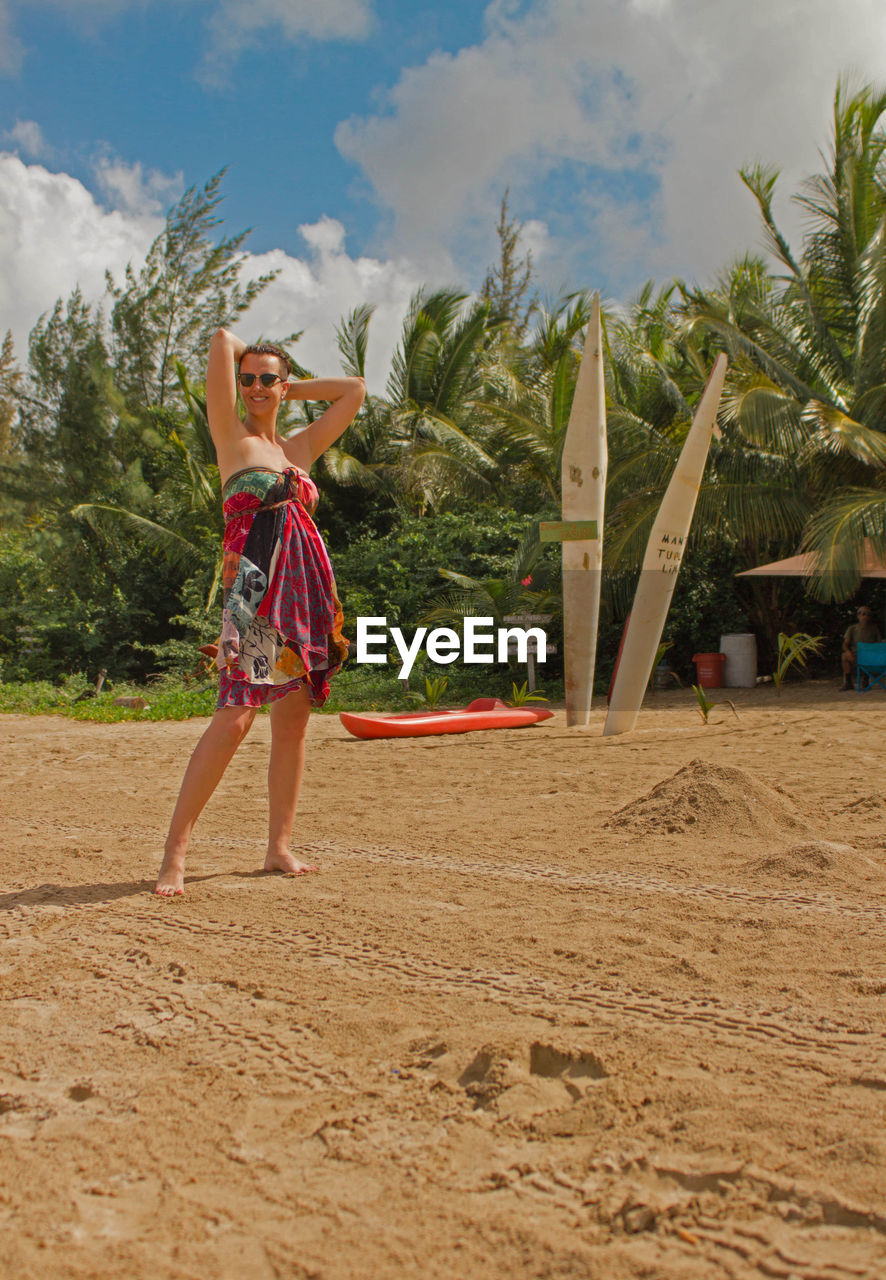 Full length of woman standing on sand at beach