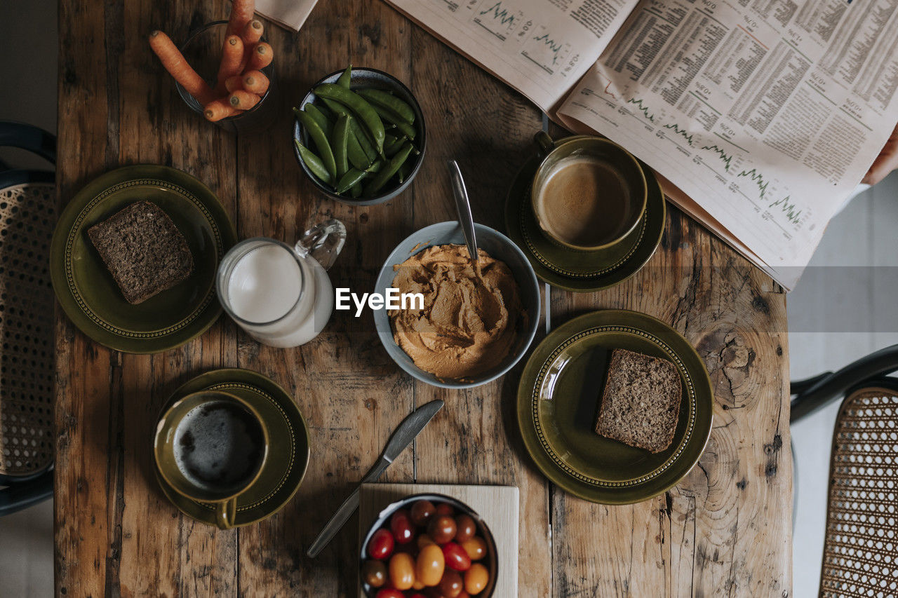 Directly above shot of breakfast arranged on wooden dining table at home