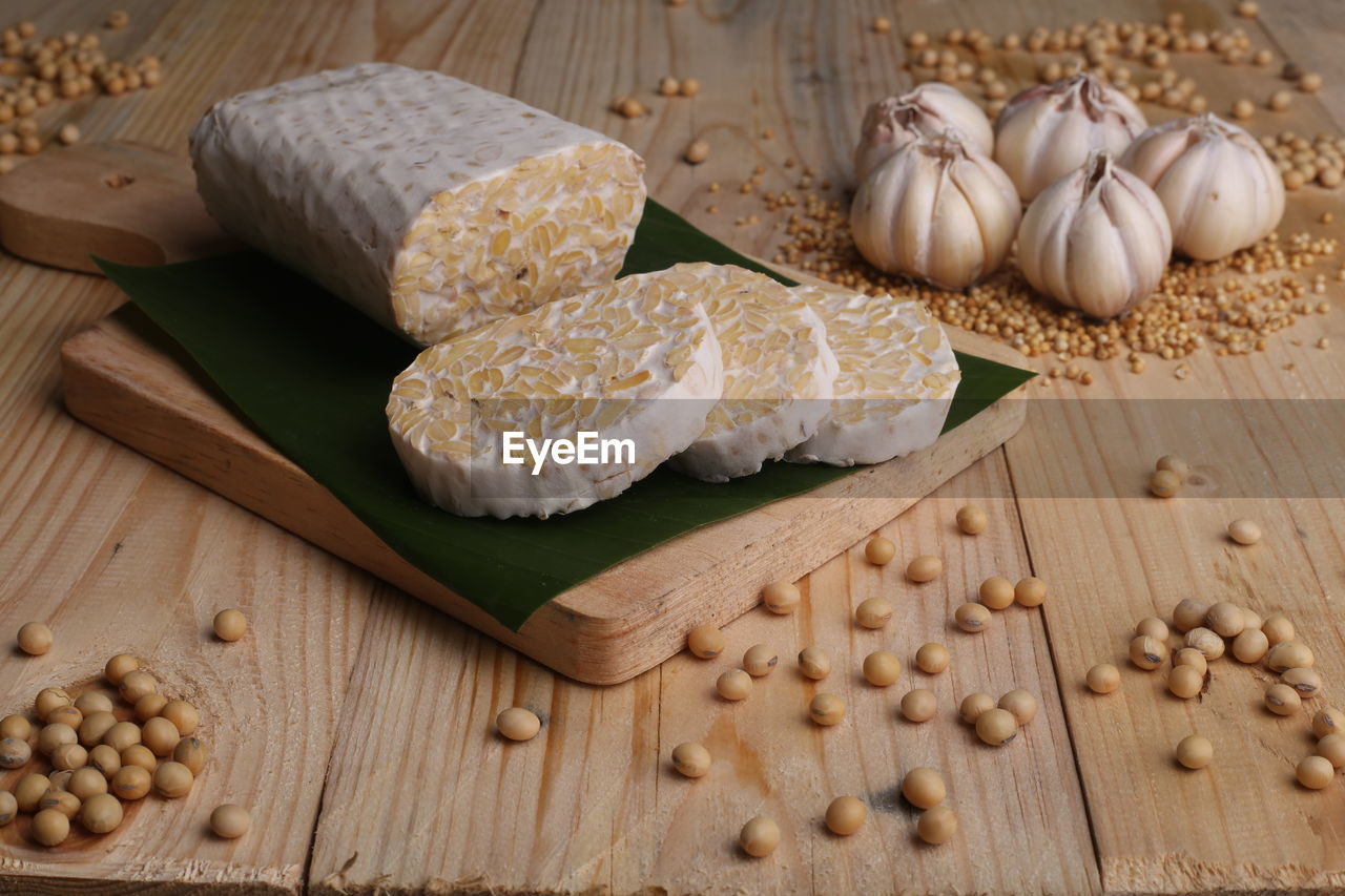 Close-up of food wrapped in banana leaves on wooden table