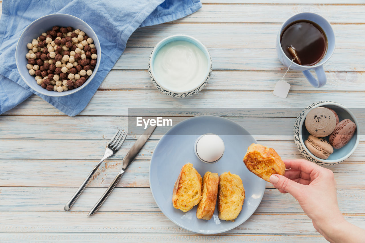 French fried toast with tea, boiled eggs and fresh yogurt. tasty farmer breakfast. flat lay