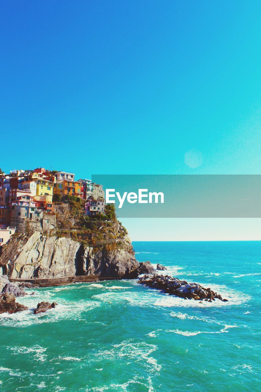 Scenic view of cinque terre against clear blue sky
