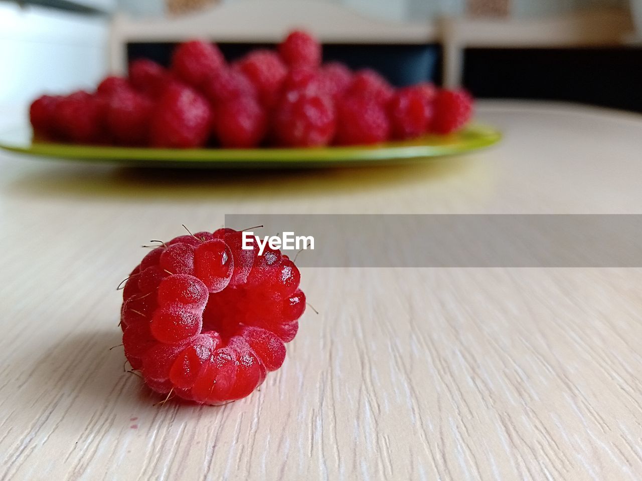 CLOSE-UP OF STRAWBERRY FRUIT ON TABLE