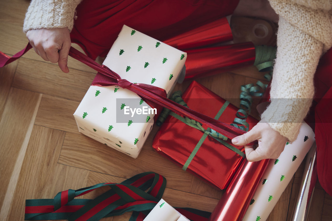 Woman's hands packing christmas presents