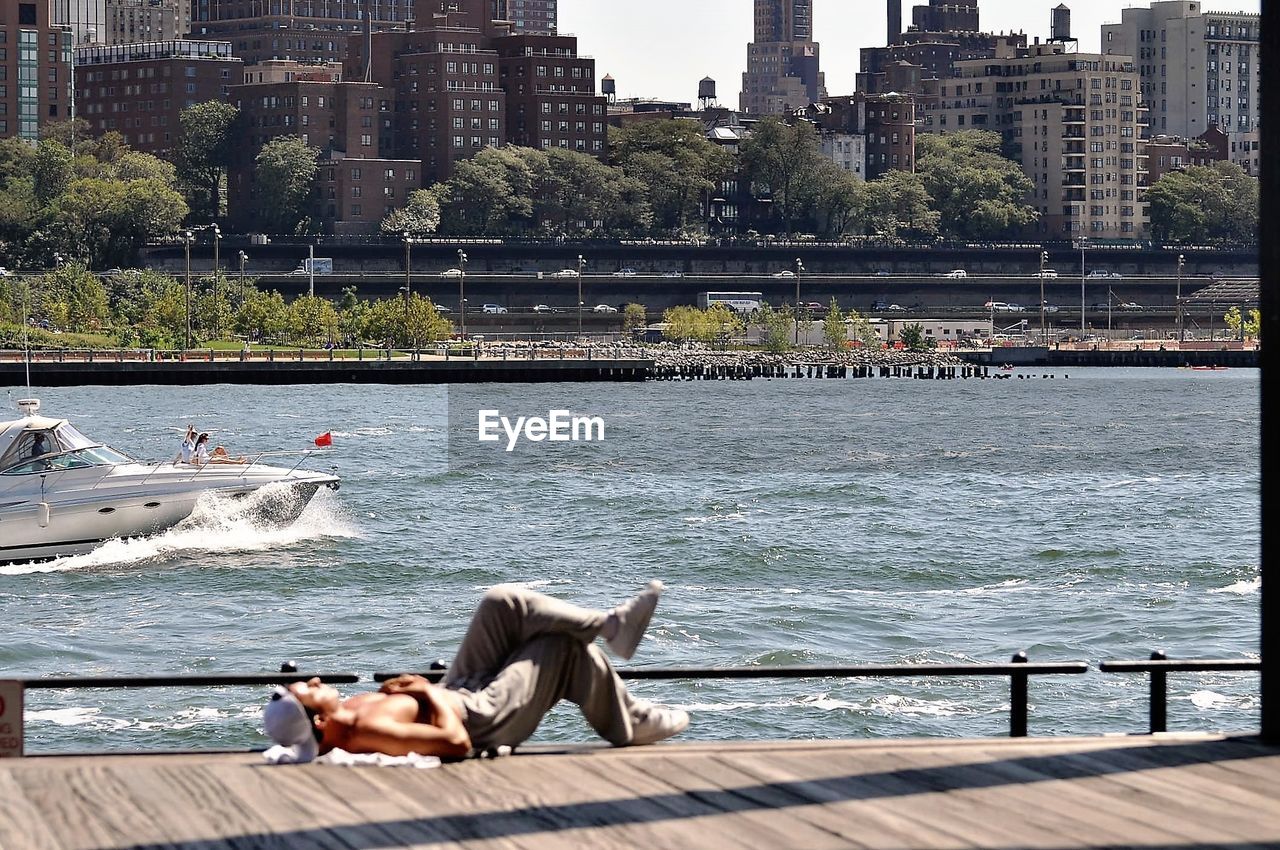 PEOPLE SITTING IN RIVER