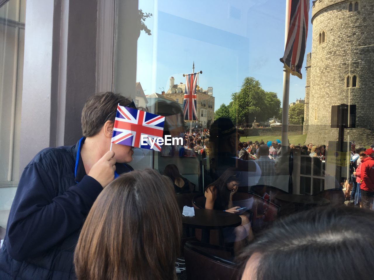 Rear view of people sitting at flags