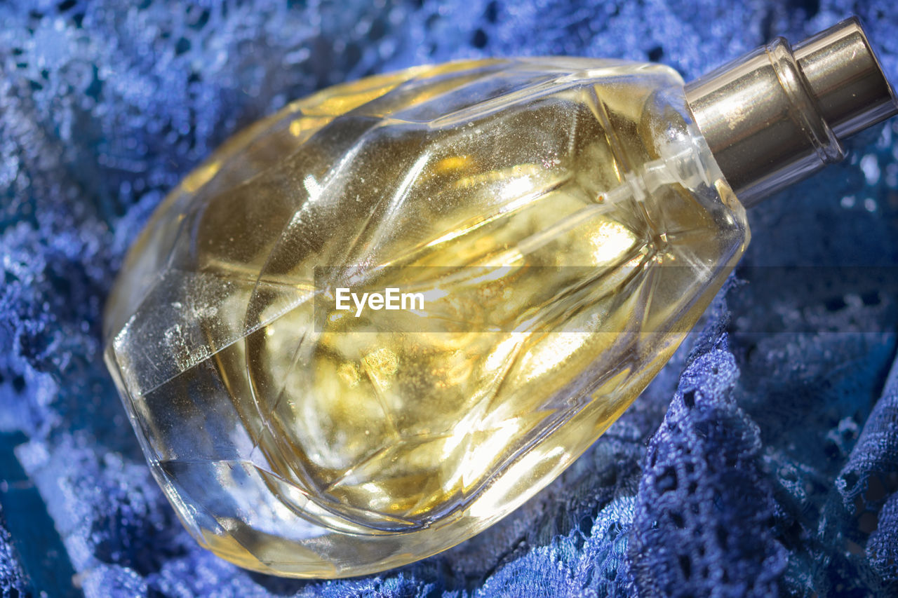 High angle view of perfume on fabric