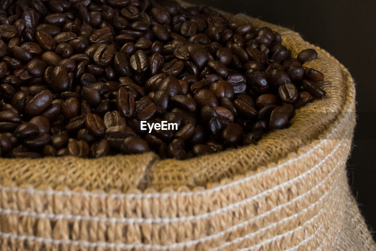 Close-up of roasted coffee beans in sack