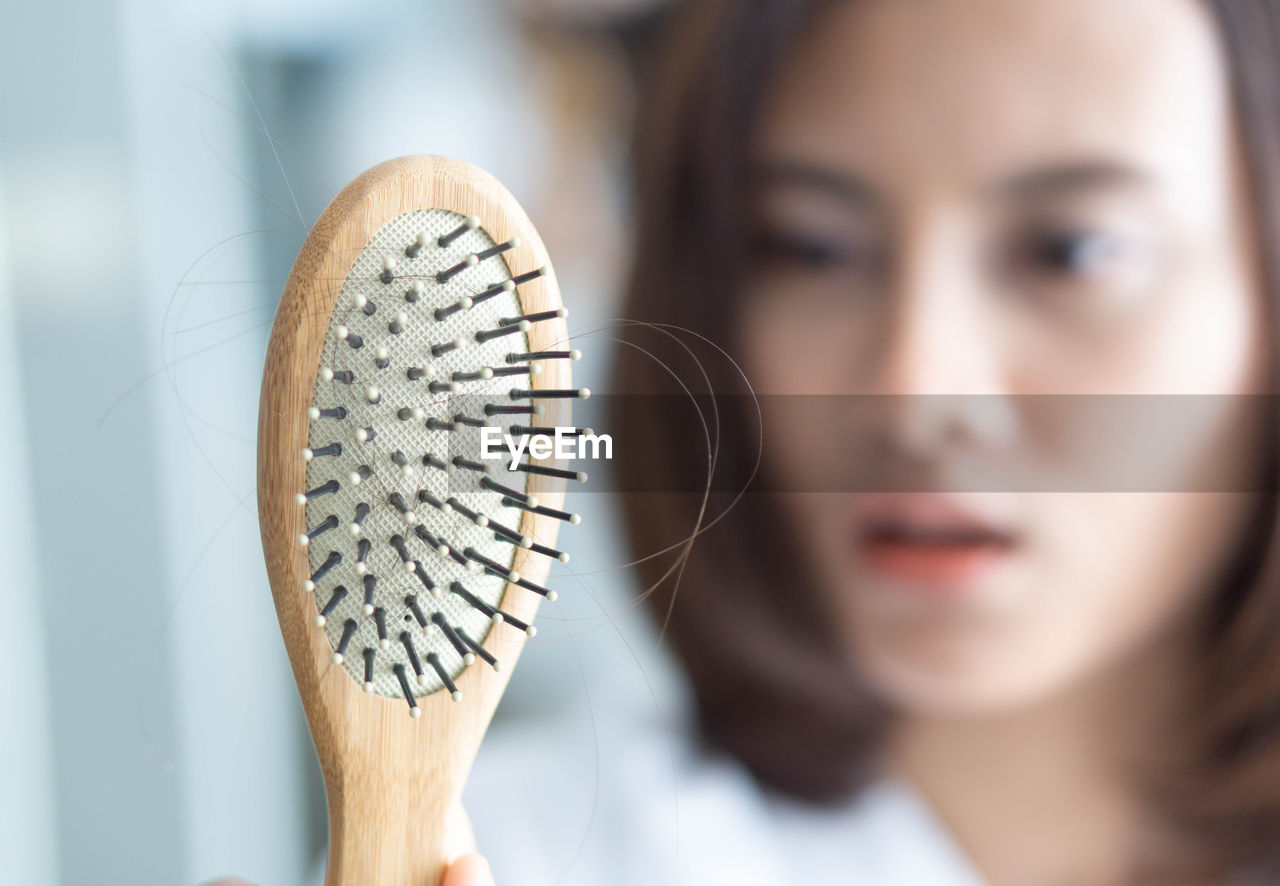 Woman showing comb with hair
