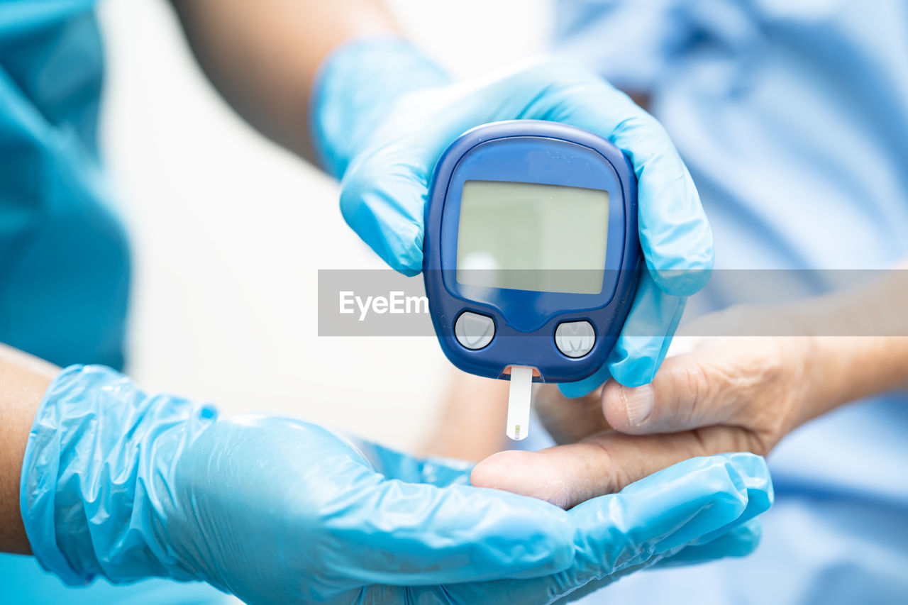 midsection of doctor examining patient in clinic