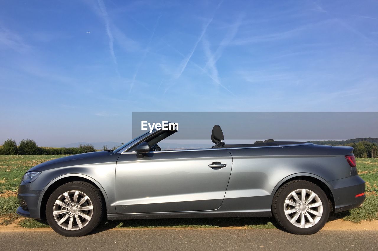 Convertible car on road against sky