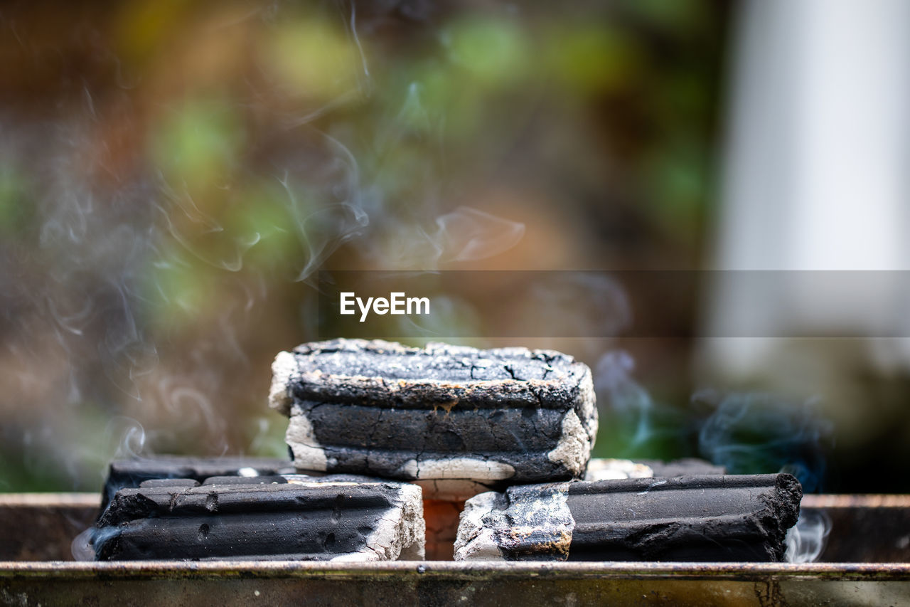 Close-up of charcoal stack on metal