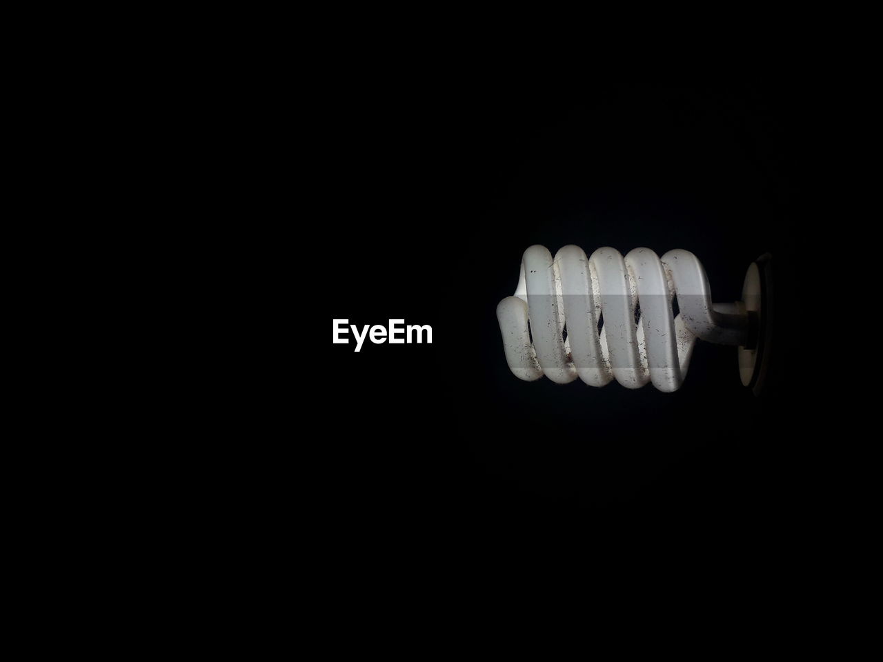 Close-up of light bulb in dark