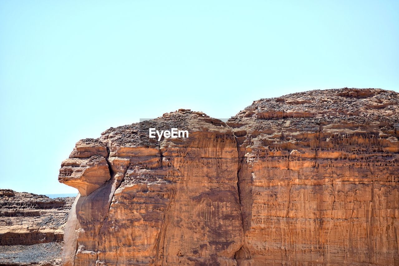 LOW ANGLE VIEW OF ROCK FORMATION AGAINST SKY