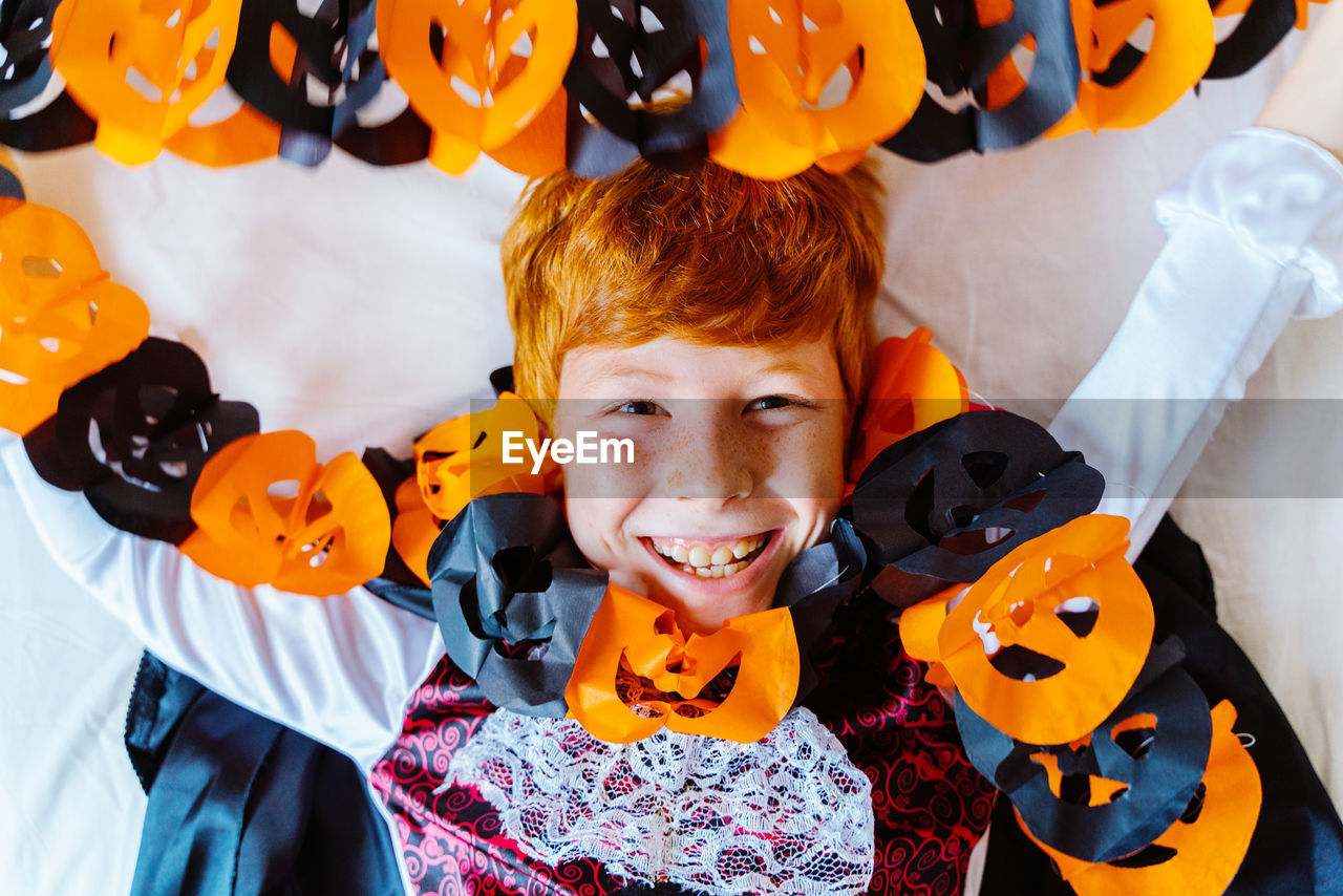 HIGH ANGLE PORTRAIT OF BOY SMILING