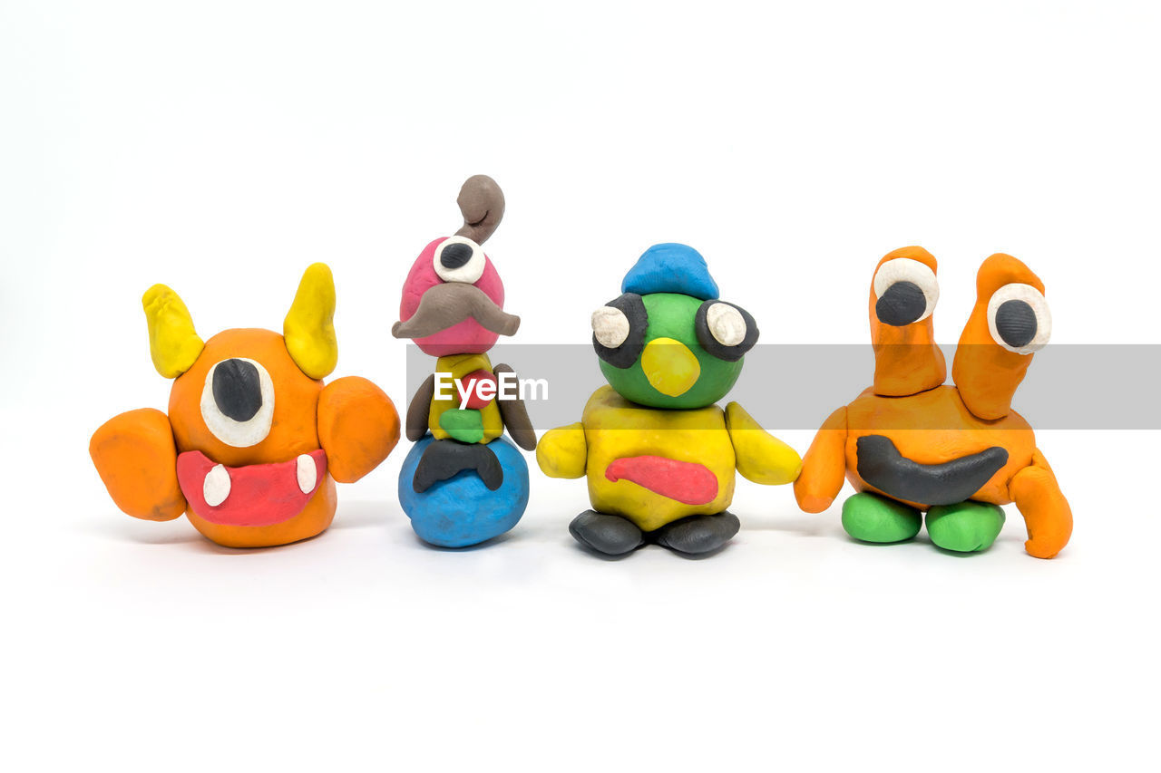 CLOSE-UP OF TOYS AGAINST GRAY BACKGROUND