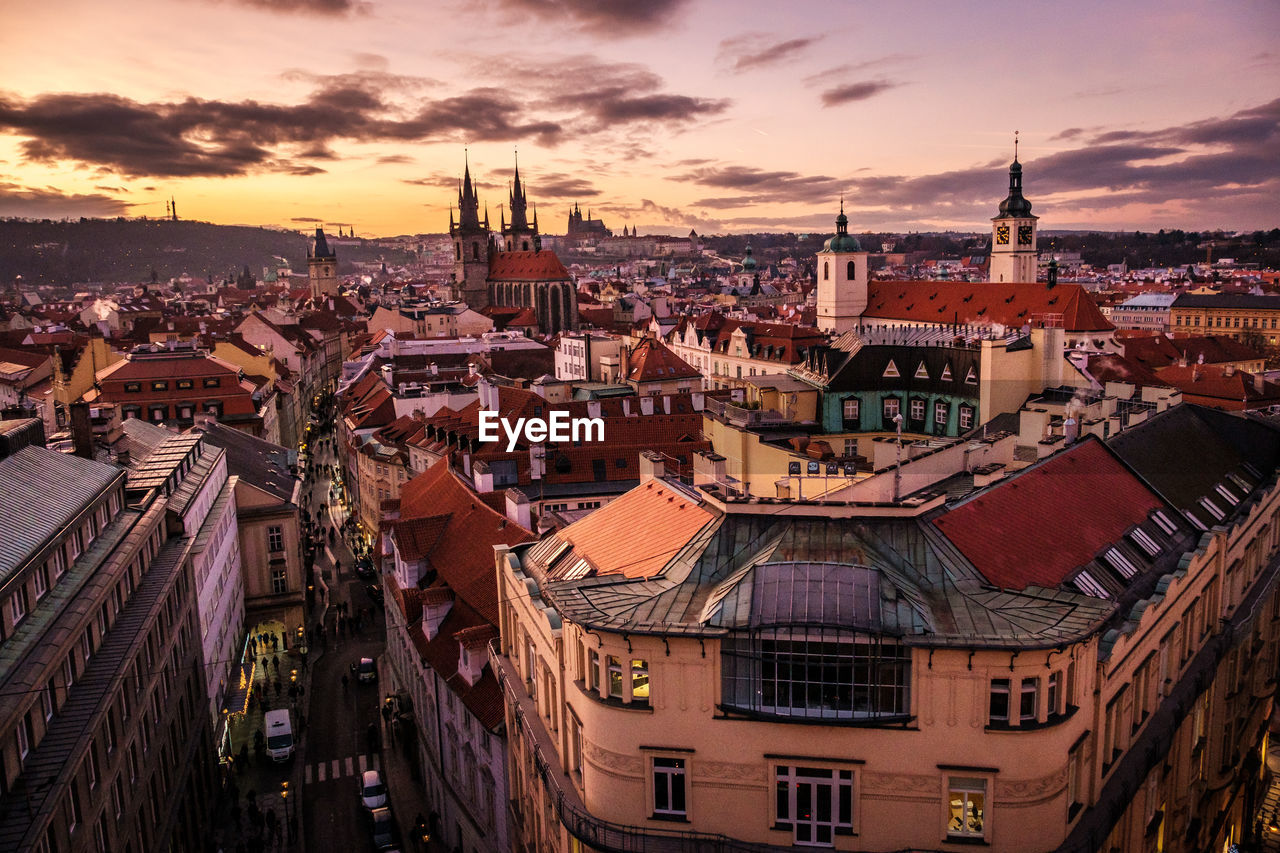 High angle view of buildings in city at sunset