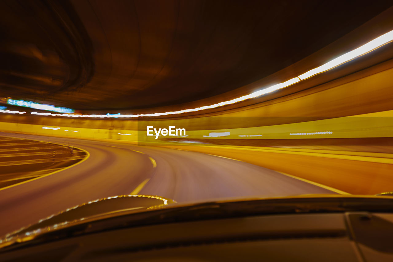 Blurred motion of illuminated lights in tunnel