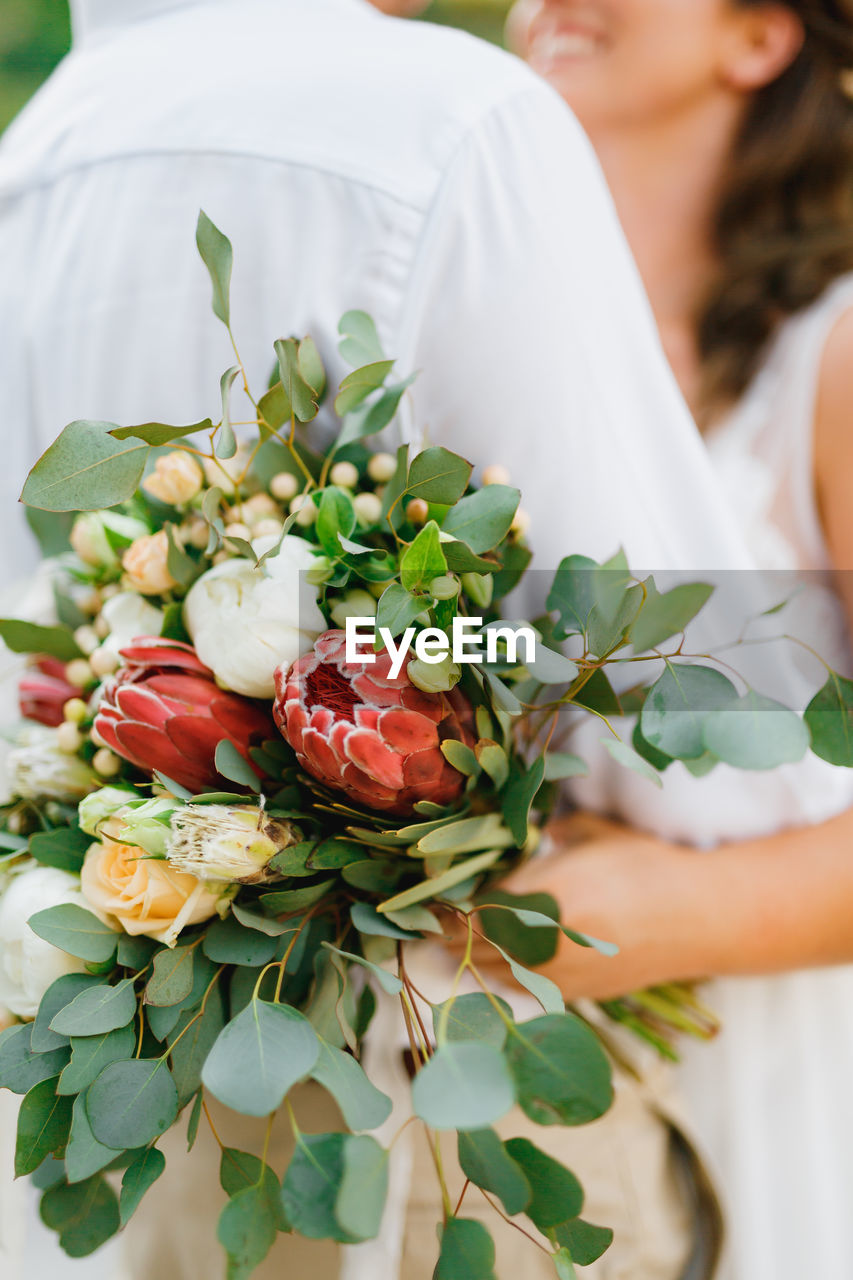 Close-up of woman holding flower bouquet