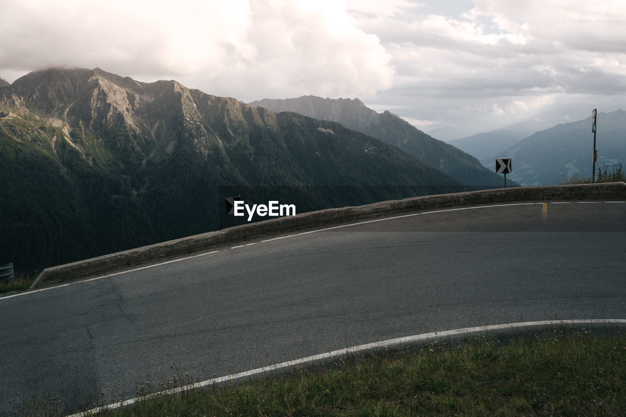 Serpentine mountain road with mountain range