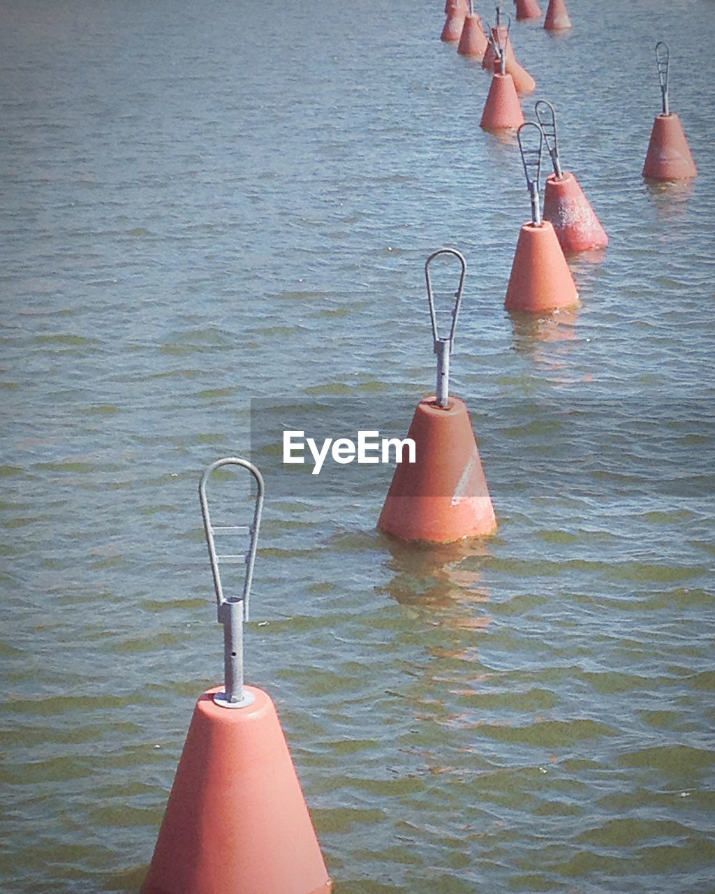 Buoys floating in river