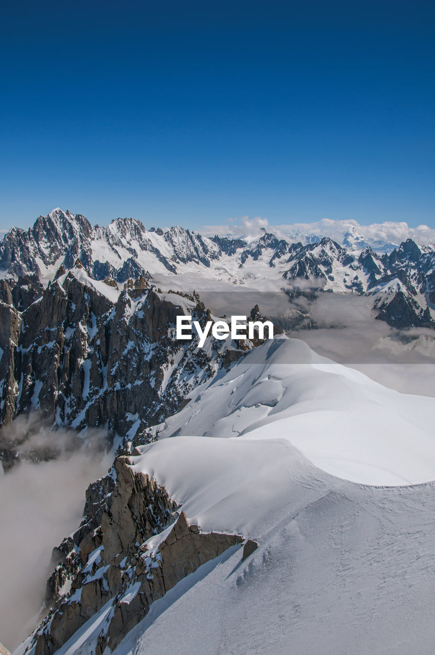 Snowy peaks and mountains in a sunny day, viewed from the aiguille du midi, near chamonix, france.