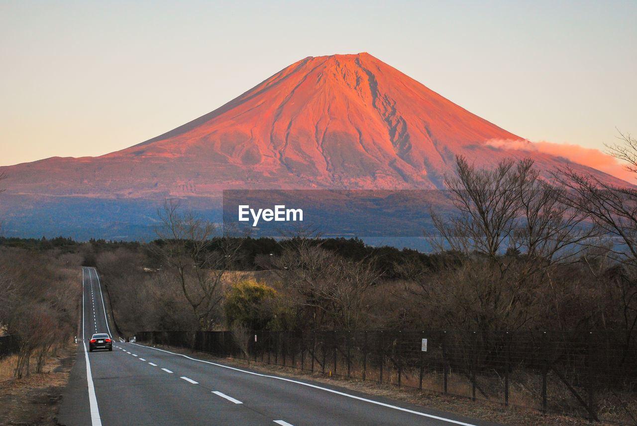 Road by mount fuji against sky