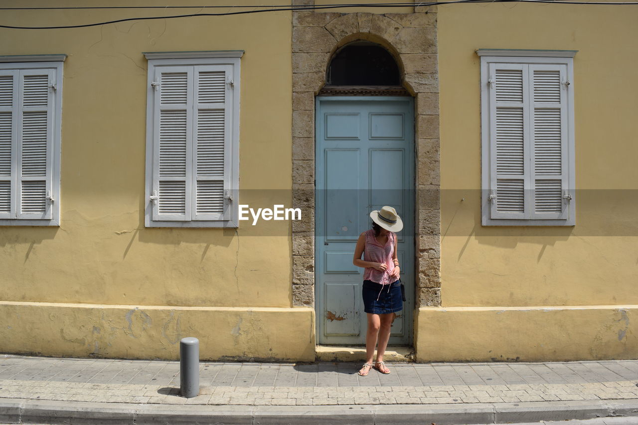 Woman standing in front of closed door