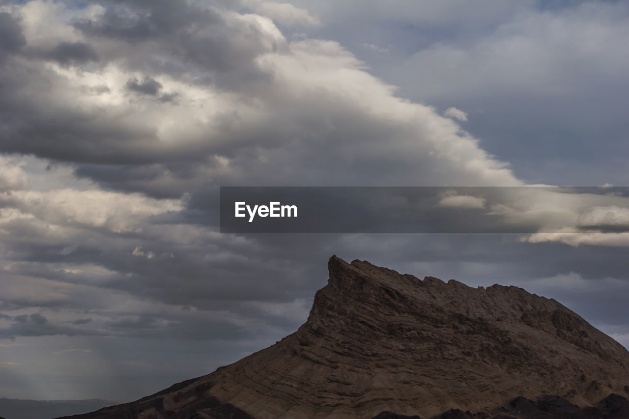 Low angle view of rock formation against sky