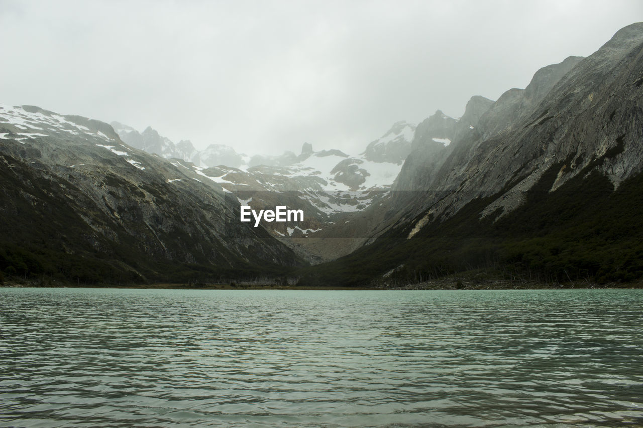 Scenic view of lake and mountains against sky