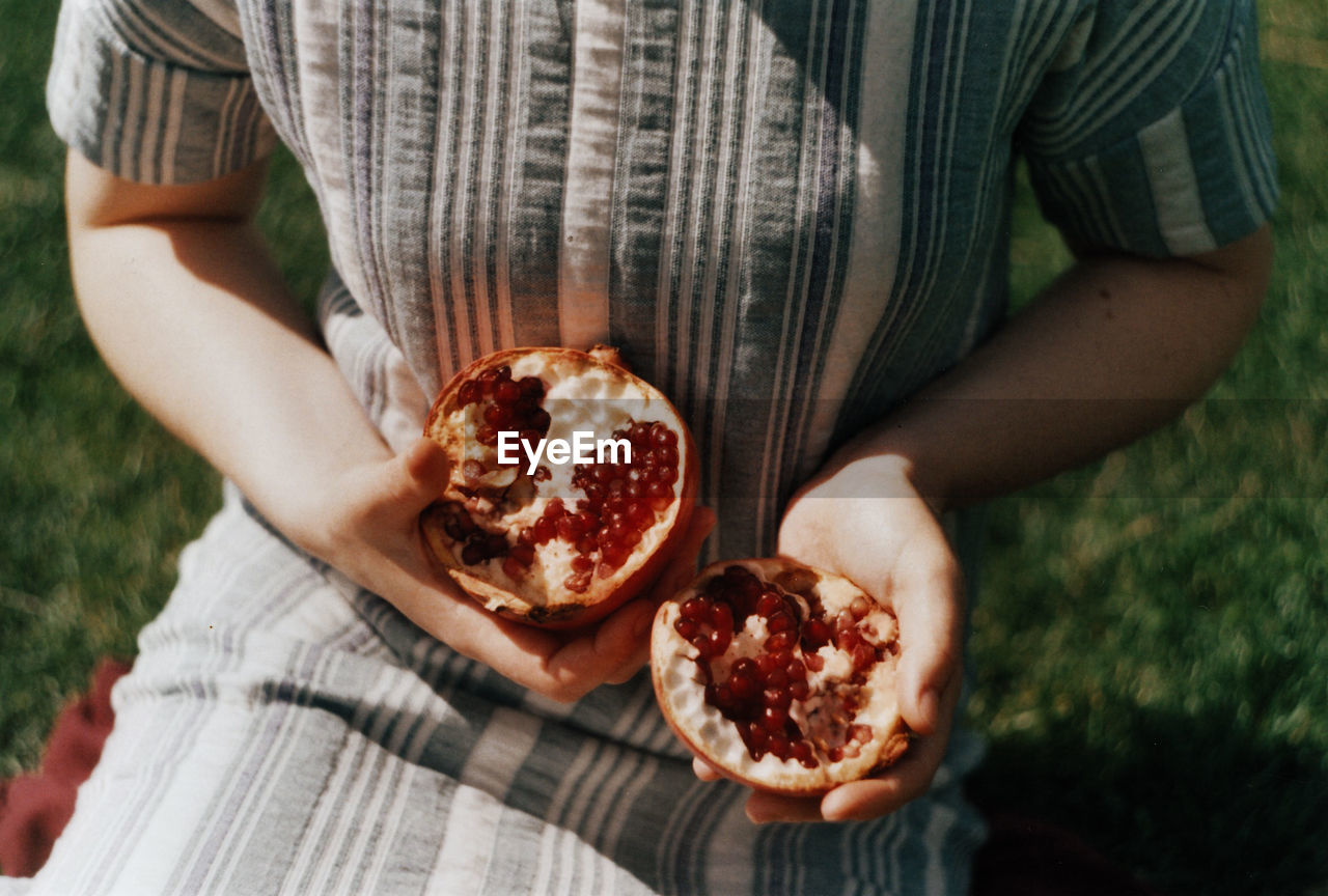 Midsection of woman holding fruits