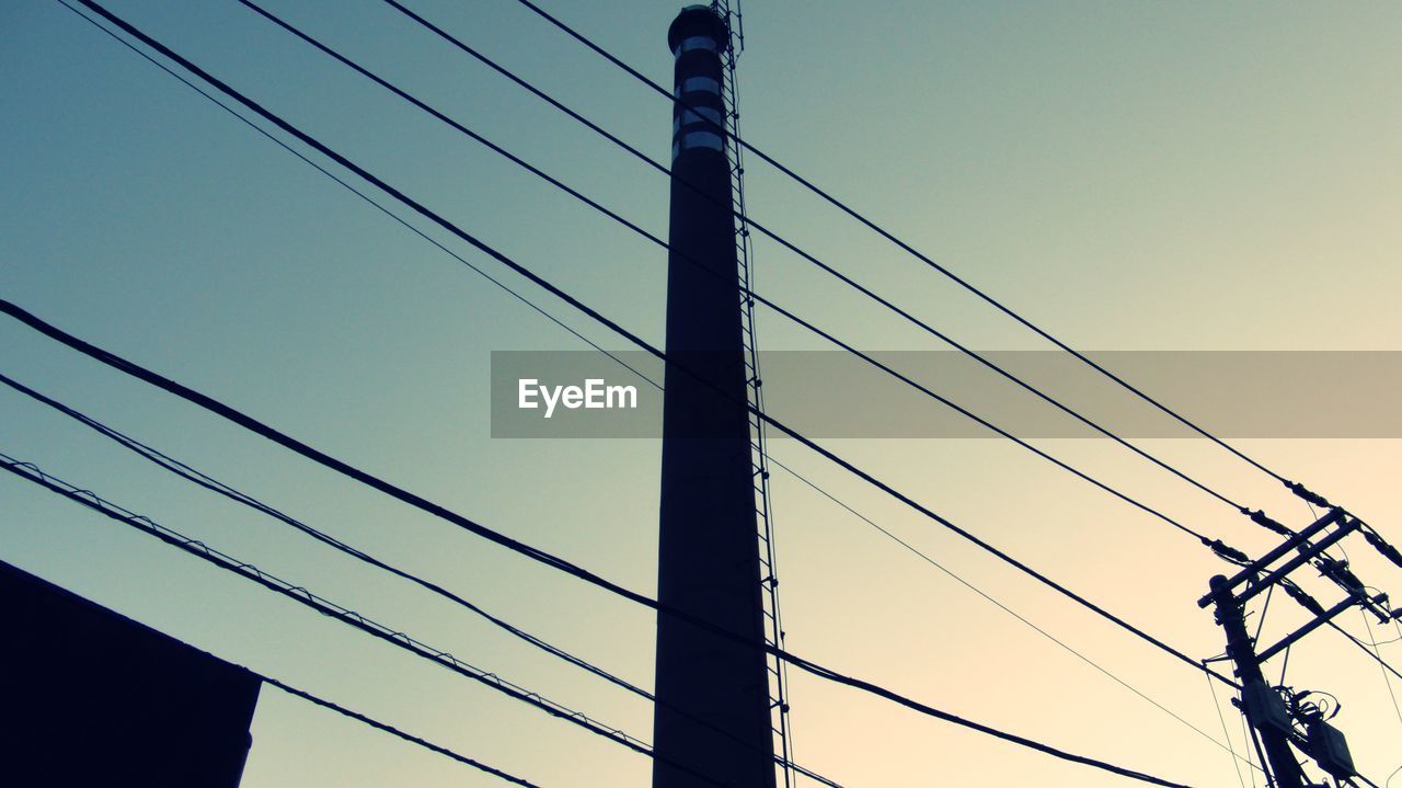 LOW ANGLE VIEW OF POWER CABLES AGAINST SKY