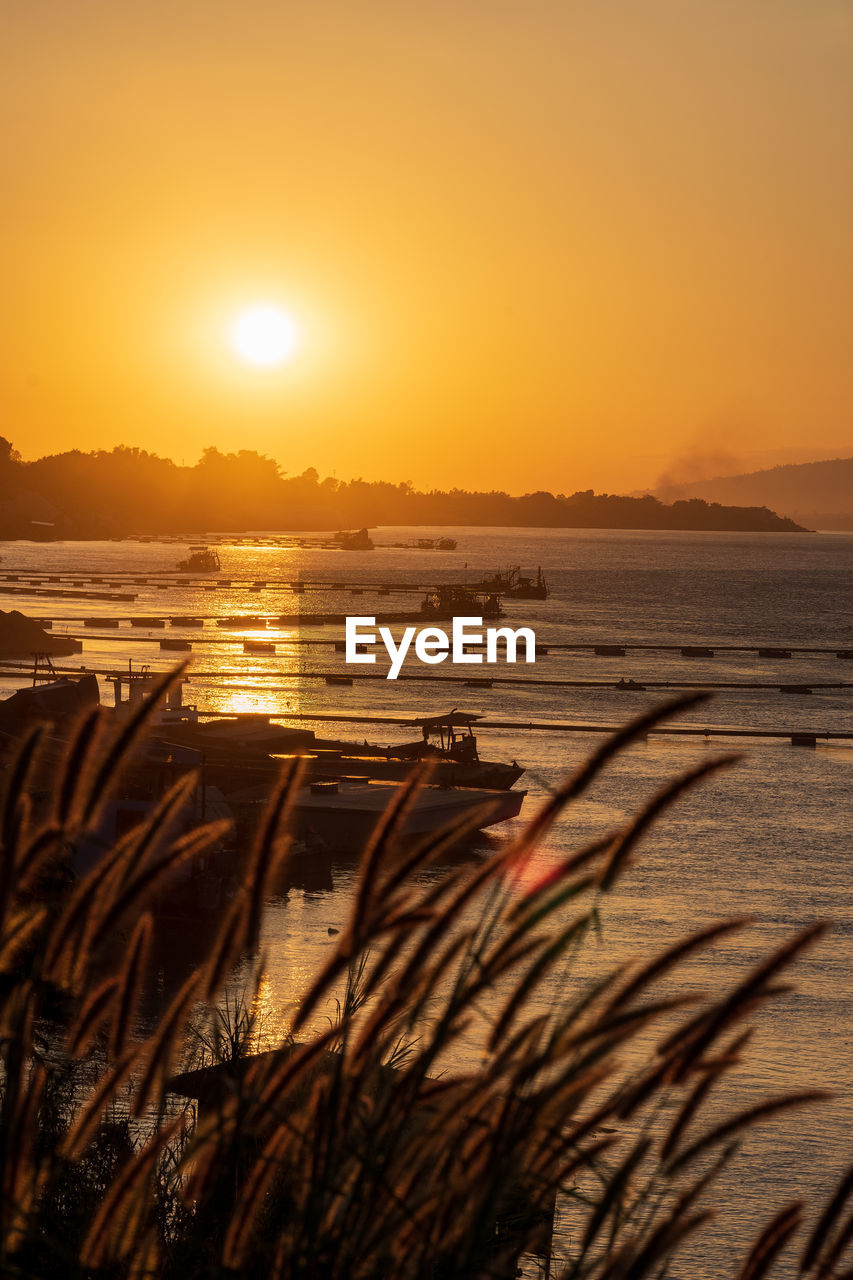 Scenic view of river against sky during sunset. sand extraction, sand suction boats.