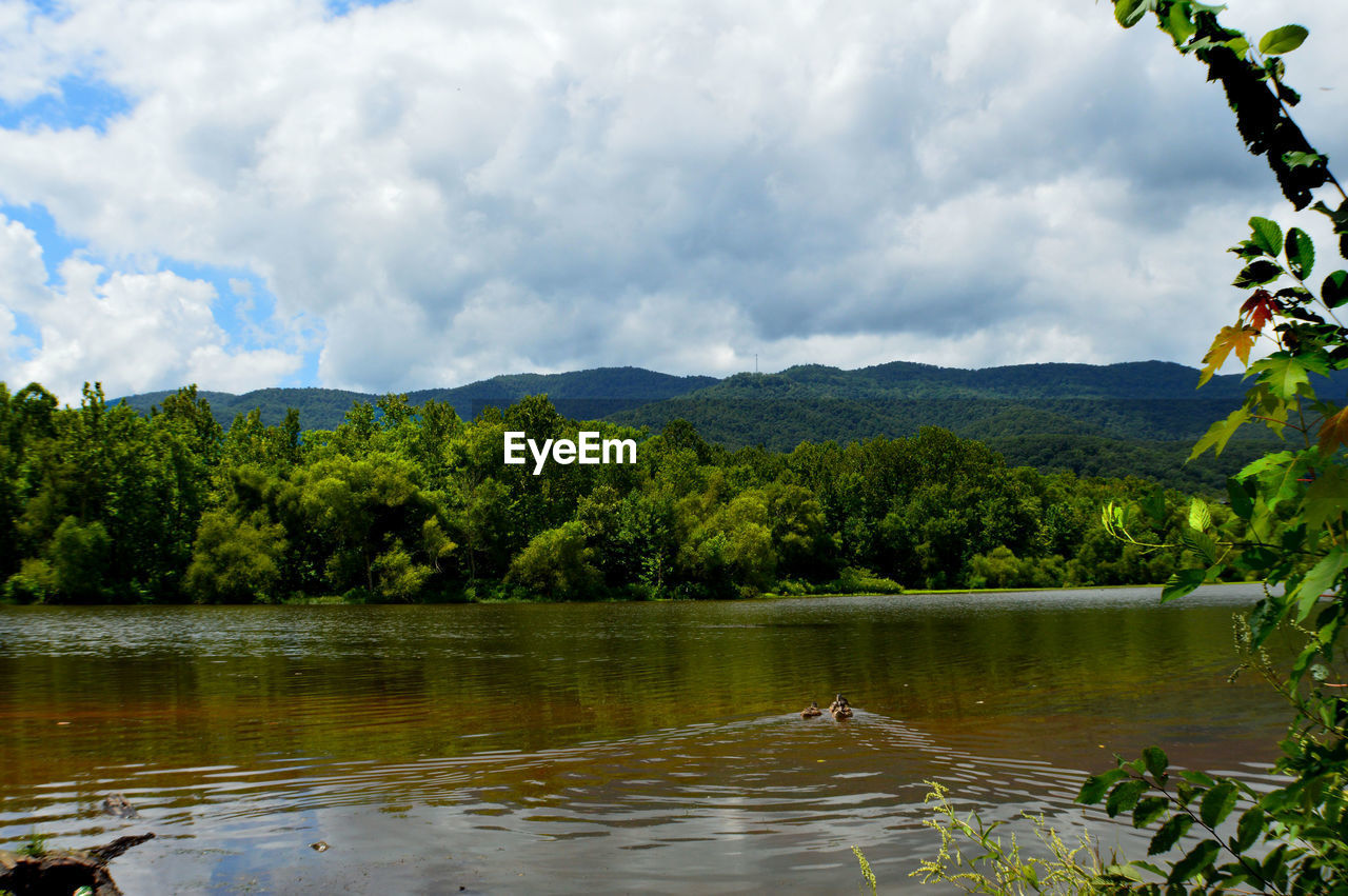 Scenic view of lake against cloudy sky