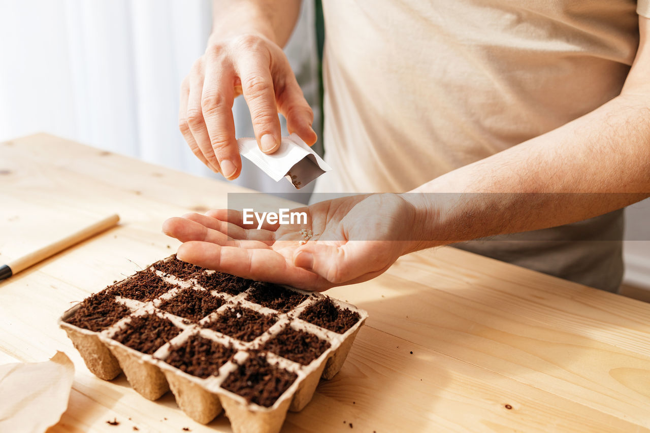 midsection of man preparing cake
