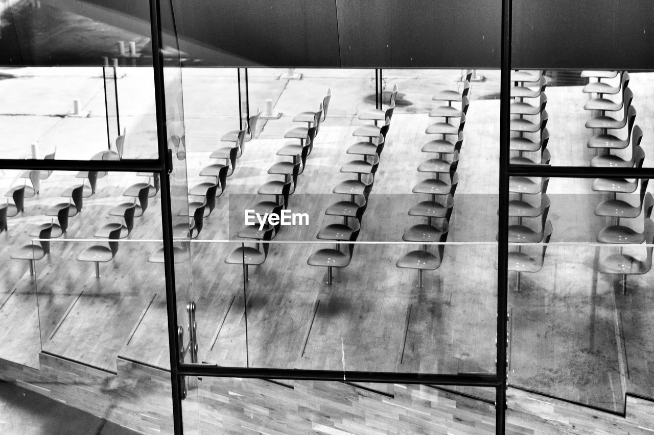 High angle view of empty chairs seen from glass window