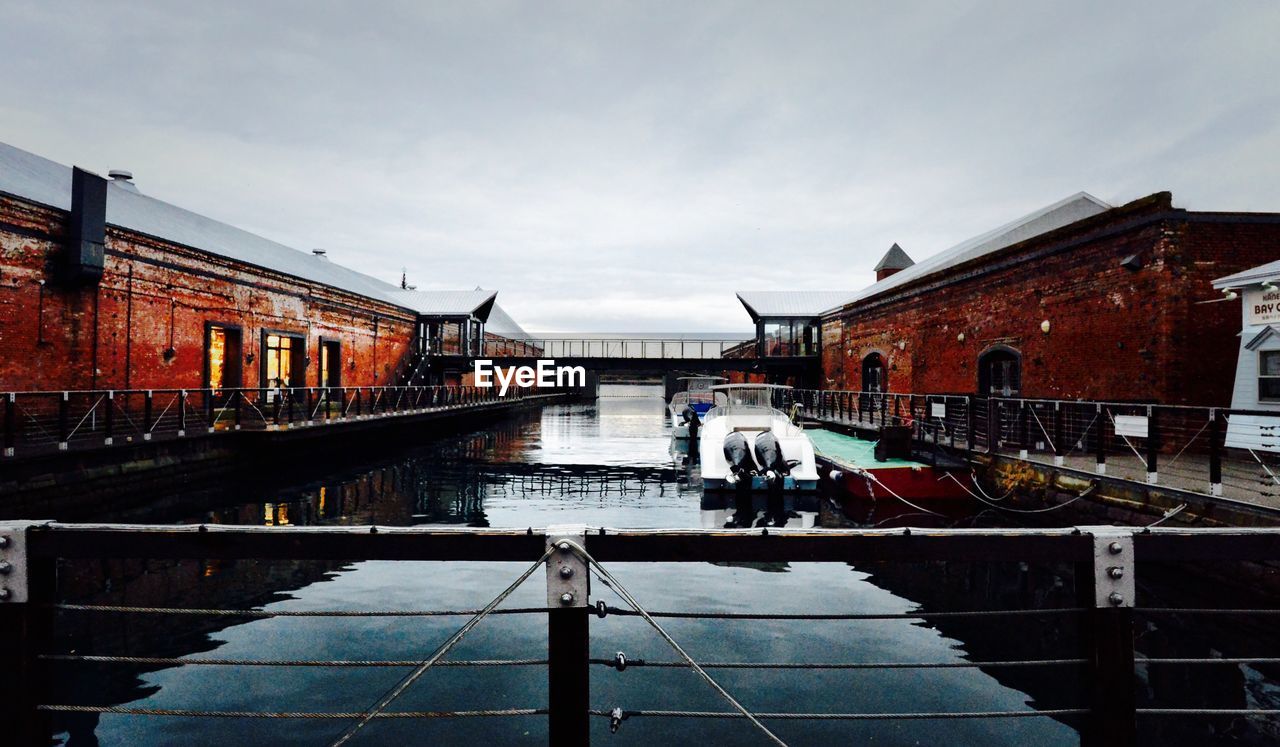 PEOPLE IN BOAT AGAINST BUILDINGS