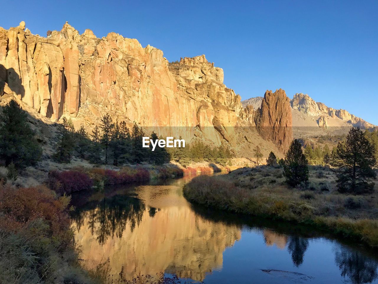 SCENIC VIEW OF LAKE AND ROCK FORMATIONS AGAINST SKY