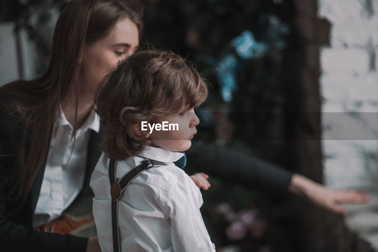 High angle view of siblings looking up outdoors