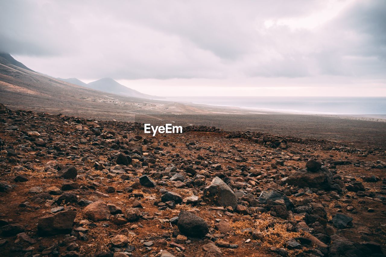 SCENIC VIEW OF ROCKS AGAINST SKY