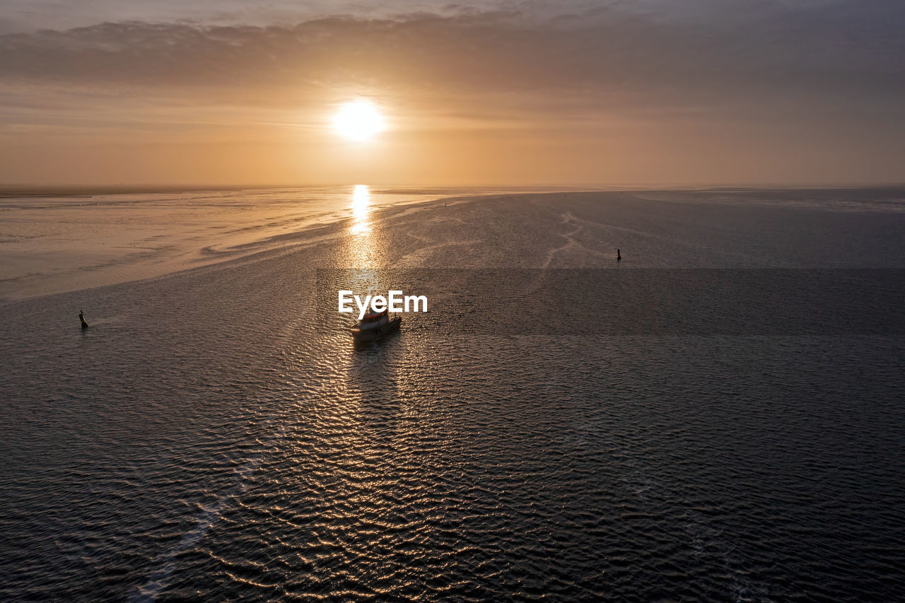 Aerial from a beautiful sunset at the wadden sea in friesland the netherlands