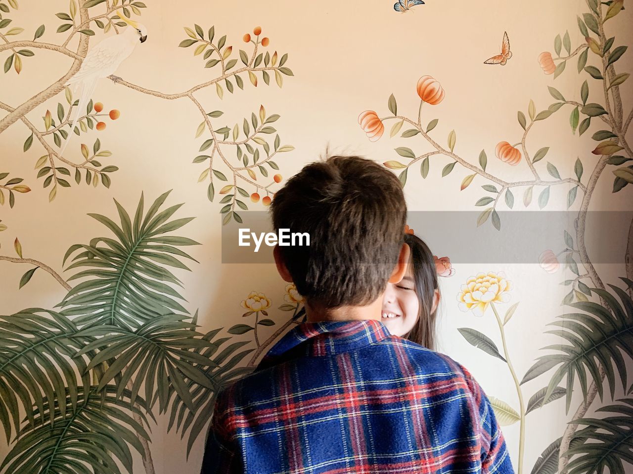 one person, rear view, men, pattern, indoors, childhood, child, wallpaper, art, person, clothing, headshot, casual clothing, plant, portrait, looking, checked pattern, adult, mural, brown hair, waist up, lifestyles