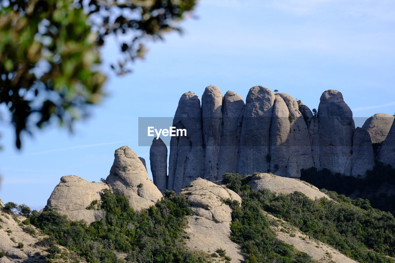 Low angle view of rocks on mountain against sky